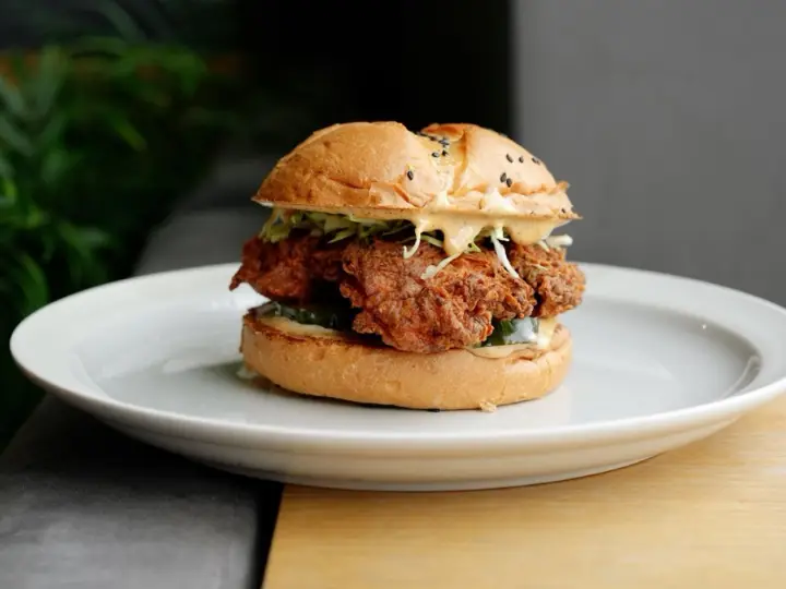 Classic fried chicken sandwich on a white plate