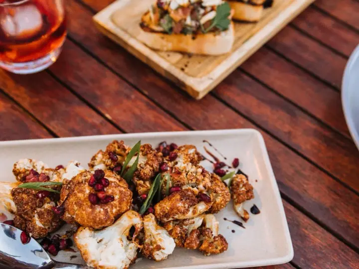 Golden fried cauliflower bites on a plate