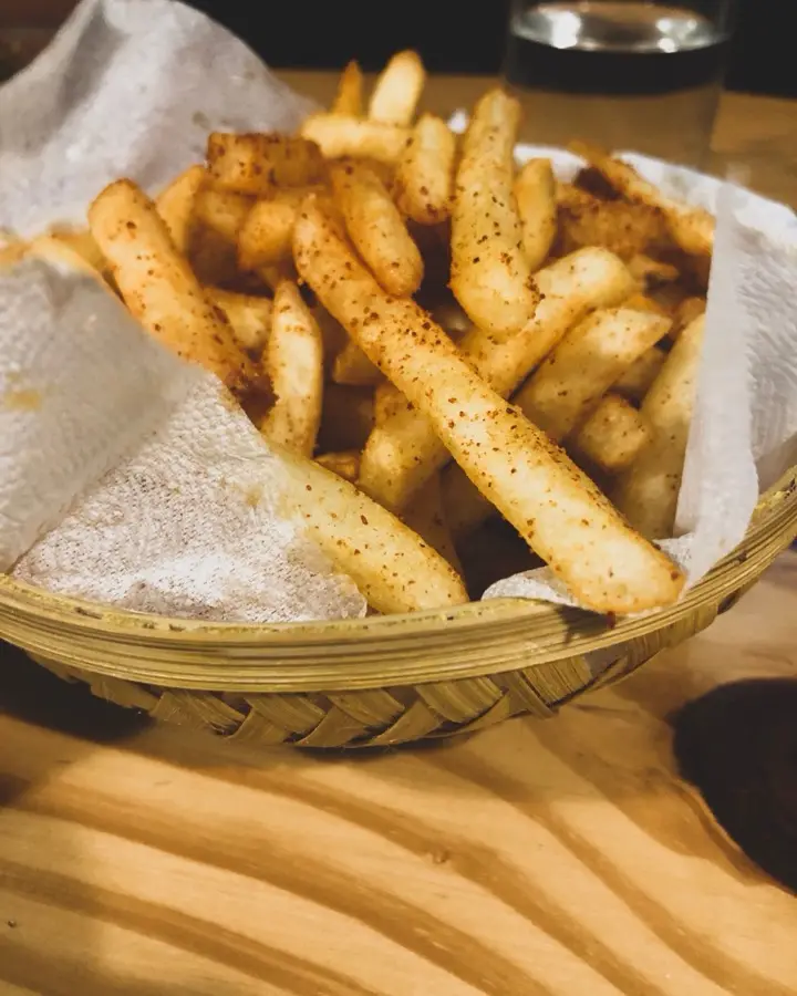 Seasoned fries in a lined basket